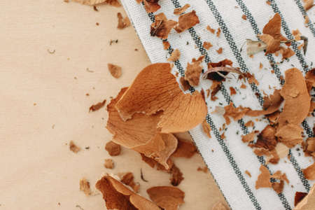 Dried yellow rose petals falls on the wooden table.の写真素材