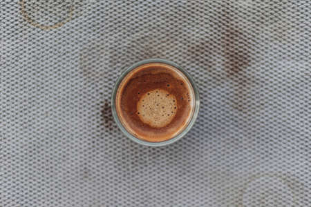 Top view of black coffee with beautiful crema on dirty grey cloth.の写真素材