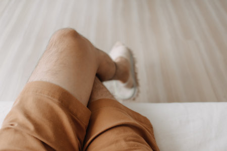 Top view of relax man sitting on sofa with crossing legs in cozy loft room.の写真素材
