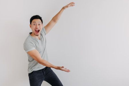 Full portrait of shock face Asian man looking at empty space isolated on white.の写真素材