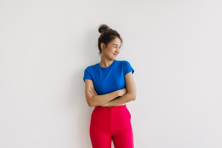 Smile and laughing asian woman with crossed arms isolated on white.の写真素材