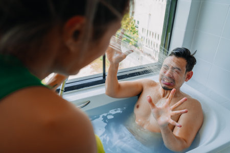 Funny playful asian couple lover play in a bathtub in the bathroom.