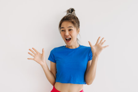 Wow and surprised face of impressed asian woman get a gift isolated on white.の写真素材