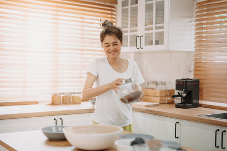 Funny candid moment of asian wife cooking for husband for the first time.の写真素材