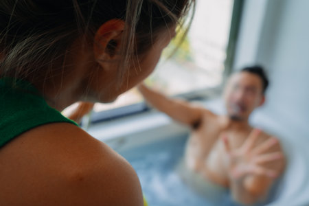 Funny playful asian couple lover play in a bathtub in the bathroom.の写真素材