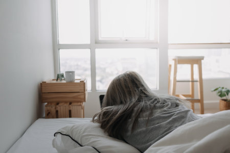 Asian woman sleep on tablet computer on bed in the morning. Early online work.