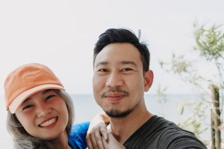 Funny and cheerful selfie portrait of asian couple lover.