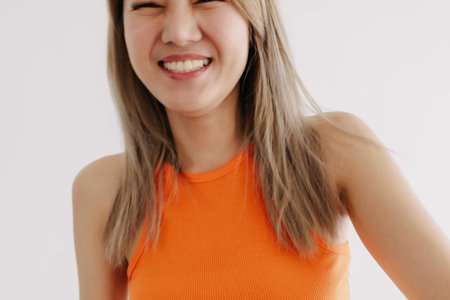 Playful and cheerful happy asian woman in colorful isolated on white.の写真素材