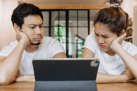 Asian couple lover in cafe get confused with application in the tablet computer.の写真素材