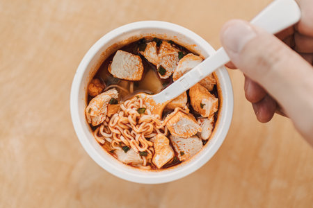 Close up top view of spicy instant noodle cup with chicken meat.の写真素材