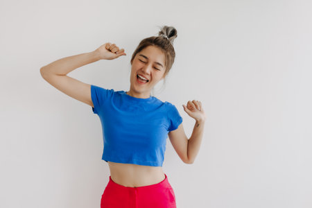 Portrait of happy cheerful asian woman in colorful clothes isolated on white.の写真素材