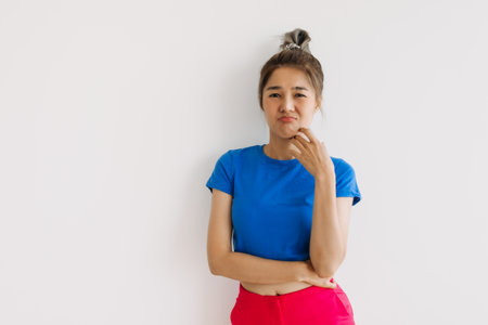 Bored and disappointed asian woman isolated on white background.の写真素材