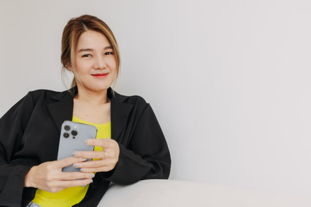 Happy and smile face asian woman using smartphone in white room.の写真素材
