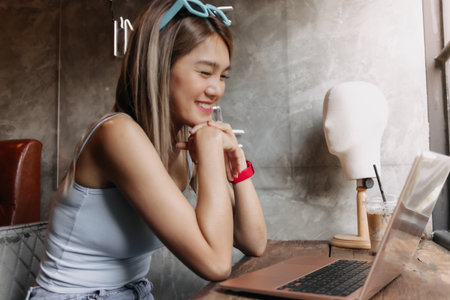 Portrait of happy freelance asian woman working creative in the cafe.の写真素材