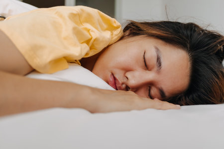 Asian woman sleeping deeply in the apartment as she tired and sick.の写真素材