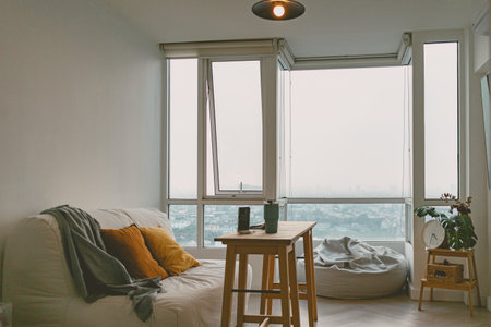 Minimal and loft living room design with iced-coffee and computer in concept of working space in...