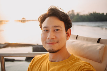 Portrait of happy smile Asian man selfie himself sits and relax for holiday trip in the resort with...