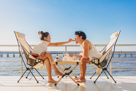 Asian couple lover enjoy their holiday at the sea in the summer with beautiful clear sky ocean.の写真素材
