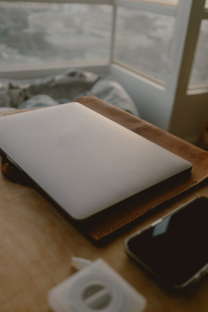 Computer laptop and mobile phone work set on wooden table in concept of home office freelance and entrepreneur.の写真素材