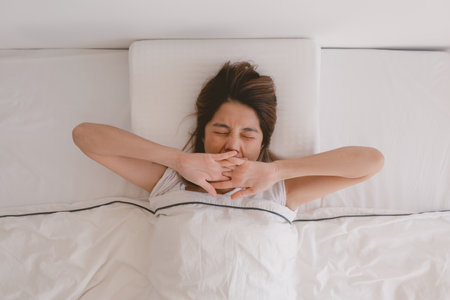 Asian woman just wake up and stretching her arms in the morning.の写真素材