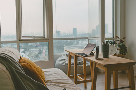 Minimal and loft living room design with iced-coffee and computer in concept of working space in evening.の写真素材