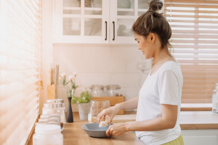 Asian woman preparing breakfast in the kitchen in the morning.の写真素材