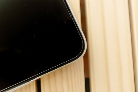 Close up of mobile phone wears white matte case left on the table.の写真素材