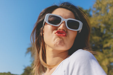 Close up of cheerful asian woman happy to be outdoor on the beach.の写真素材
