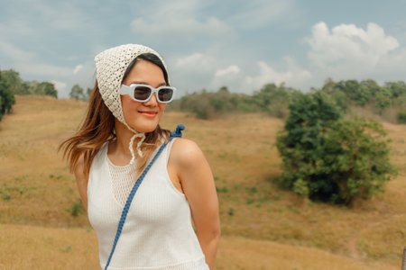 Asian woman enjoy getting outdoor with hills and fields at the national park.の写真素材
