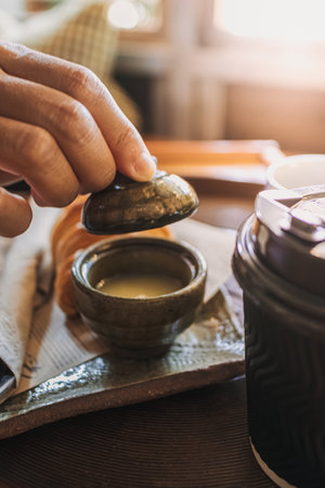 Close up of woman hands making a simple tea.の写真素材