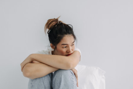 Sad and depressed asian woman stay alone in the room.