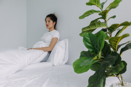 Sad and depressed asian woman stay alone in the room.の写真素材
