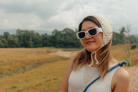Asian woman enjoy getting outdoor with hills and fields at the national park.の写真素材