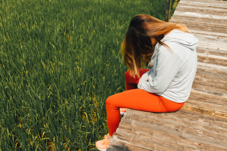 Asian woman resting at the rice fields after working out in the morning.の写真素材
