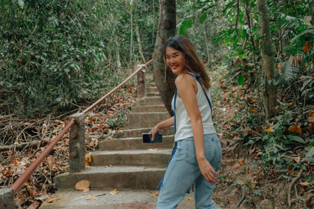 Asian woman feels tired and exhausted walking in the forest preserved park.の写真素材