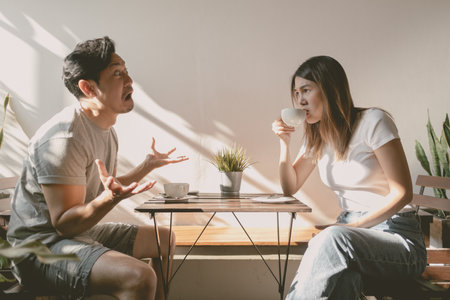 Asian man and woman having conversation with funny face expression.の写真素材