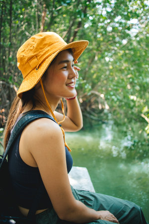Lovely Happy Asian woman relax in the mangrove forest outdoor activity.の写真素材
