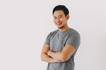 Smart smile asian man cross arms feels happy and confident isolated on white.の写真素材