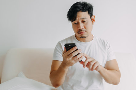 Sad asian man trying to call and connect to someone but no answer.の写真素材