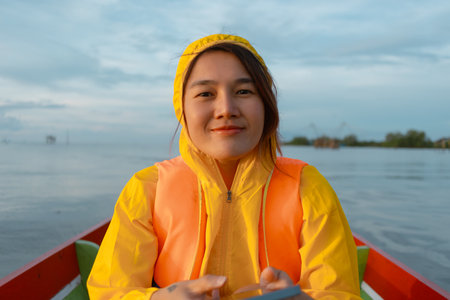 Close up of happy asian woman on a boat trip across the lake in Thailand.の写真素材