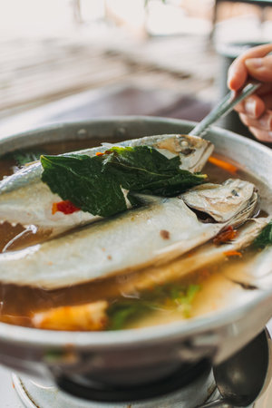 Thai Spicy Mackerel Soup served on the wooden table.の写真素材