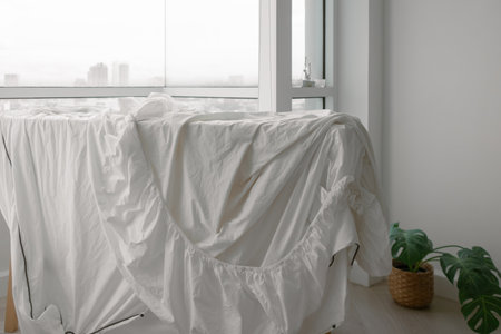 White bed sheets hanging after wash at the balcony of the apartment..の写真素材