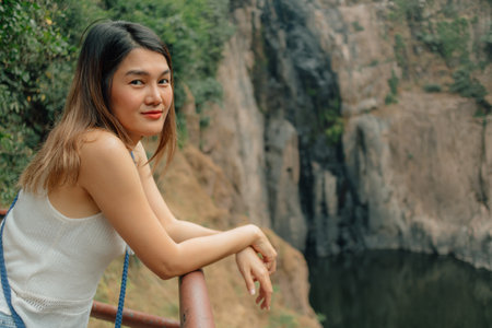 Happy asian woman enjoy tropical forest preserved park, Thailand.の写真素材