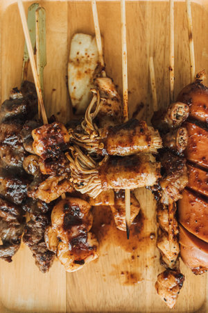Mala skewers served on the wooden plate. Popular asian food.の写真素材