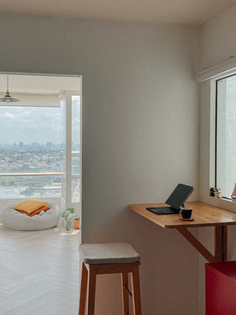 Minimal home working space wooden desk with computer tablet and coffee.の写真素材