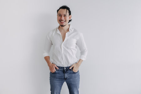 Happy face long hair Asian man bun in white shirt and jean stand on white.の写真素材