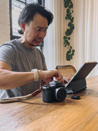 Furious photographer Asian man working in rush as it is at deadline.の写真素材