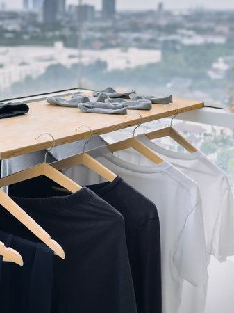 Black and white clothes are hanging at the balcony in the cloudy day.
