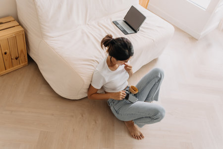 Asian woman relax with tv and mobile phone, enjoy her lifestyle in living room.の写真素材