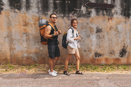 Asian couple tourist backpacker walking along the street in Asia old town.の写真素材